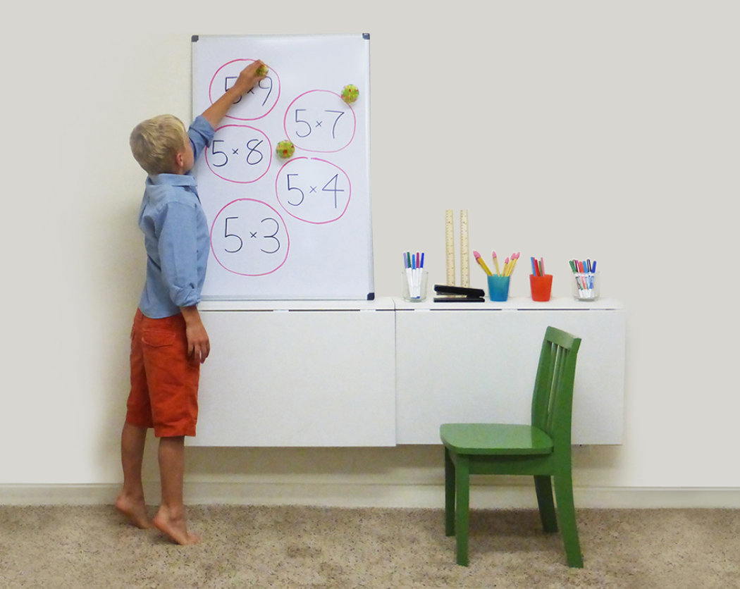 A child writing on a white board